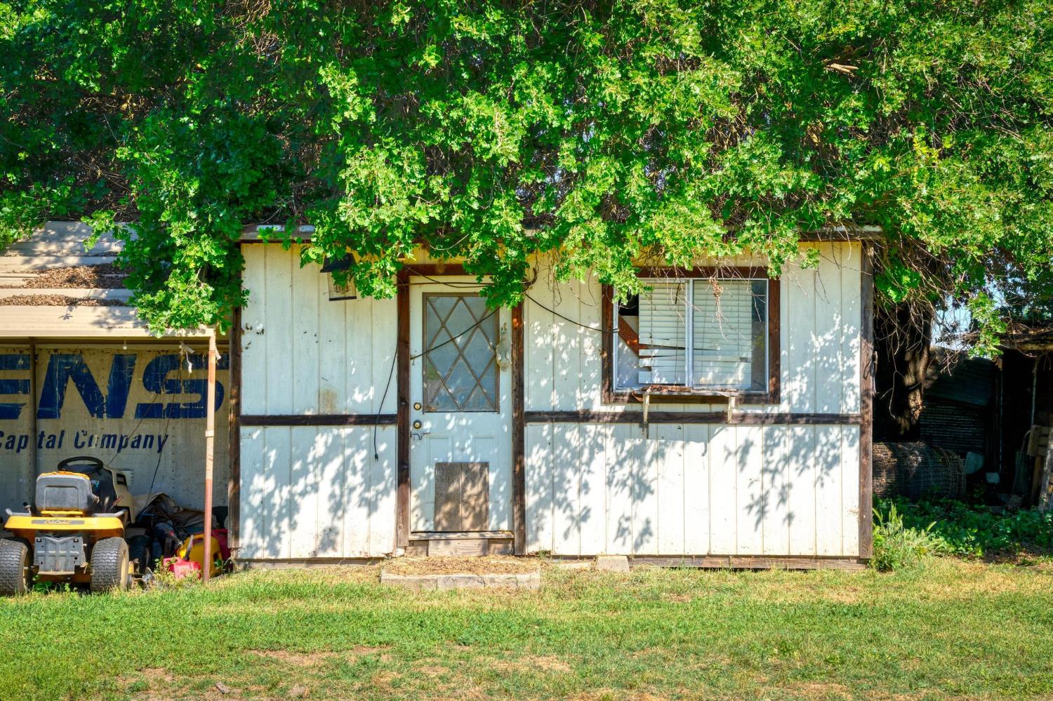 12518 Lone Oak Road Waterford, CA 95386 - Photo 47 of 50 a view of a backyard with wooden fence and a large tree