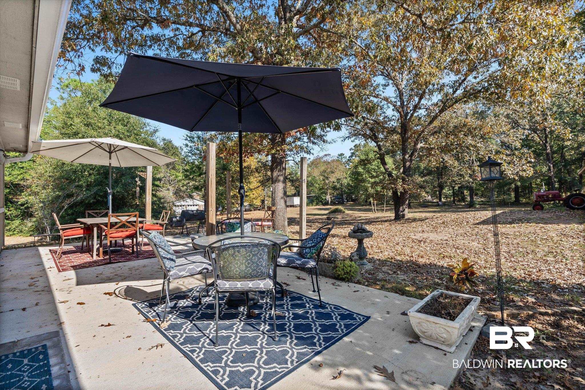 3846 Leslie Road Saraland, AL 36571 - Photo 23 of 40 View of patio featuring outdoor dining area and view of wooded area