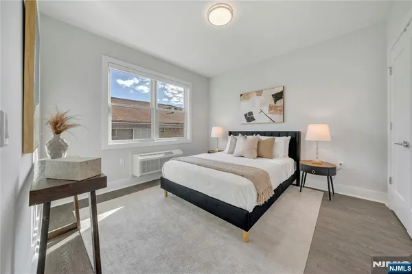 a bedroom with a bed and wooden floor