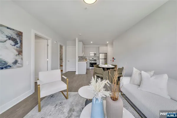 a living room with furniture and kitchen view