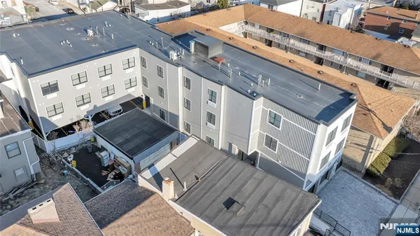 an aerial view of residential houses with city view