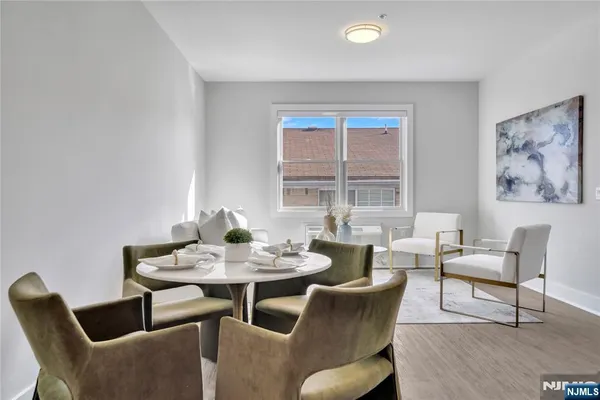 a dining room with furniture and wooden floor
