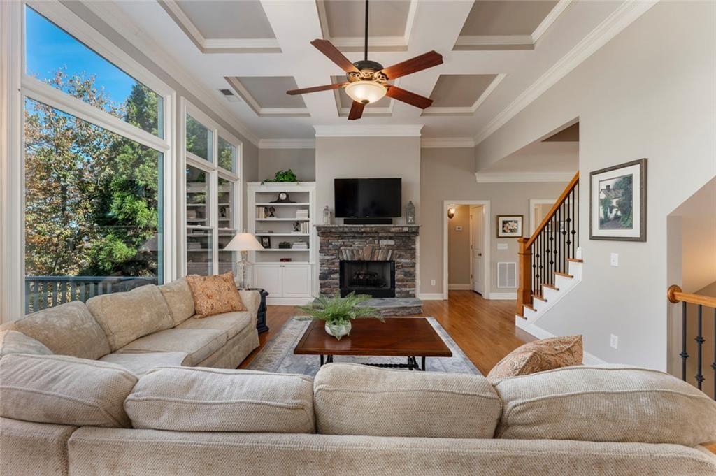 300 Tupelo Trail Canton, GA 30114 - Photo 11 of 50 a living room with furniture a fireplace and a flat screen tv