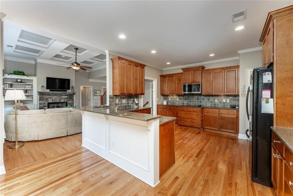 300 Tupelo Trail Canton, GA 30114 - Photo 13 of 50 a large kitchen with cabinets wooden floor and stainless steel appliances