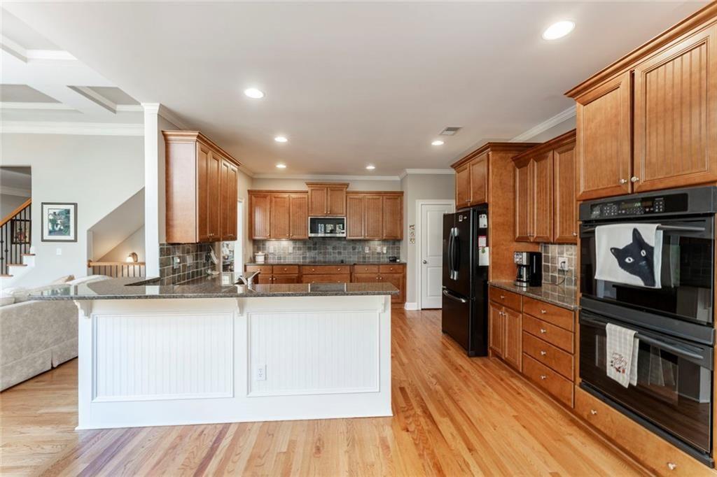 300 Tupelo Trail Canton, GA 30114 - Photo 18 of 50 a kitchen with stainless steel appliances granite countertop a refrigerator a stove top oven and a sink