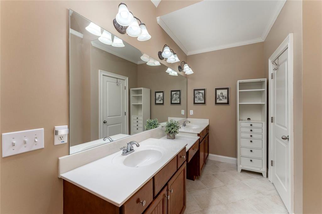 300 Tupelo Trail Canton, GA 30114 - Photo 23 of 50 a bathroom with a sink a vanity and a mirror