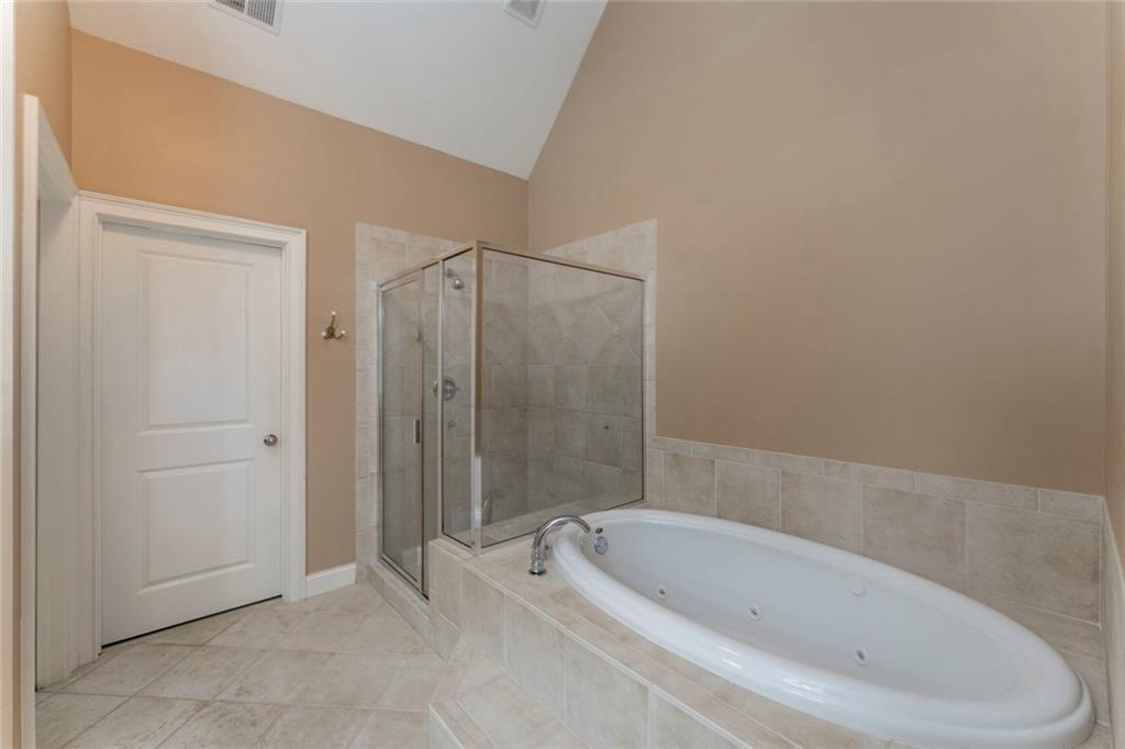 300 Tupelo Trail Canton, GA 30114 - Photo 24 of 50 a bathroom with a bathtub and shower