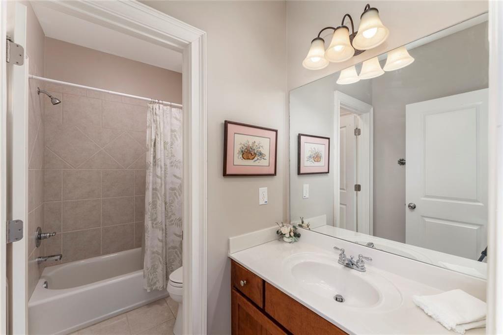 300 Tupelo Trail Canton, GA 30114 - Photo 28 of 50 a bathroom with a sink a light fixture and a mirror