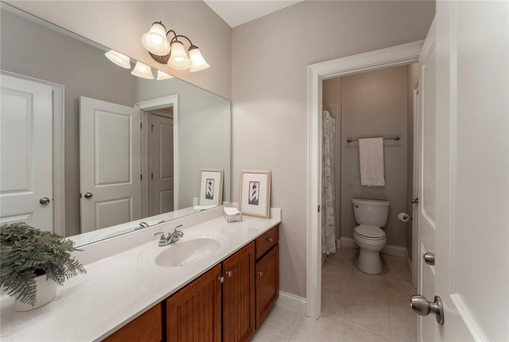 300 Tupelo Trail Canton, GA 30114 - Photo 29 of 50 a bathroom with a double vanity sink a toilet and a mirror