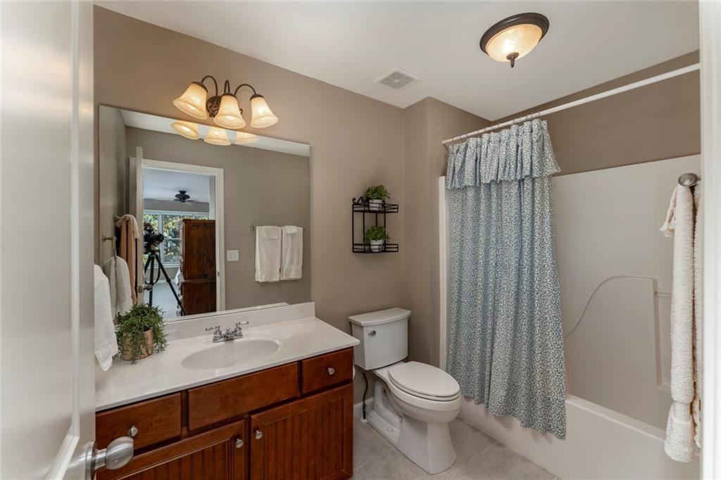 300 Tupelo Trail Canton, GA 30114 - Photo 36 of 50 a bathroom with a sink a toilet and shower