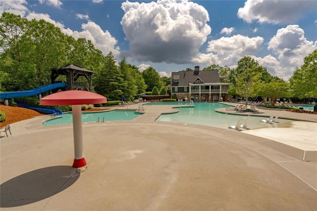 300 Tupelo Trail Canton, GA 30114 - Photo 46 of 50 a street view with flower plants and wooden fence