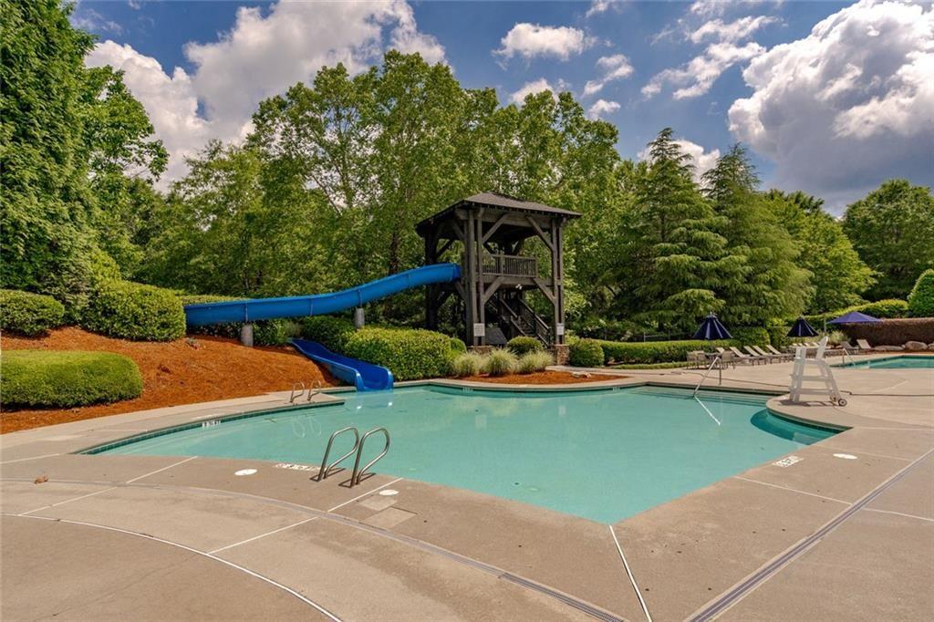 300 Tupelo Trail Canton, GA 30114 - Photo 47 of 50 a view of a swimming pool with a garden and trees
