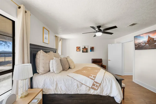 a large kitchen with stainless steel appliances lots of counter space and wooden floor