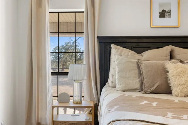 a bedroom with a bed and glass window