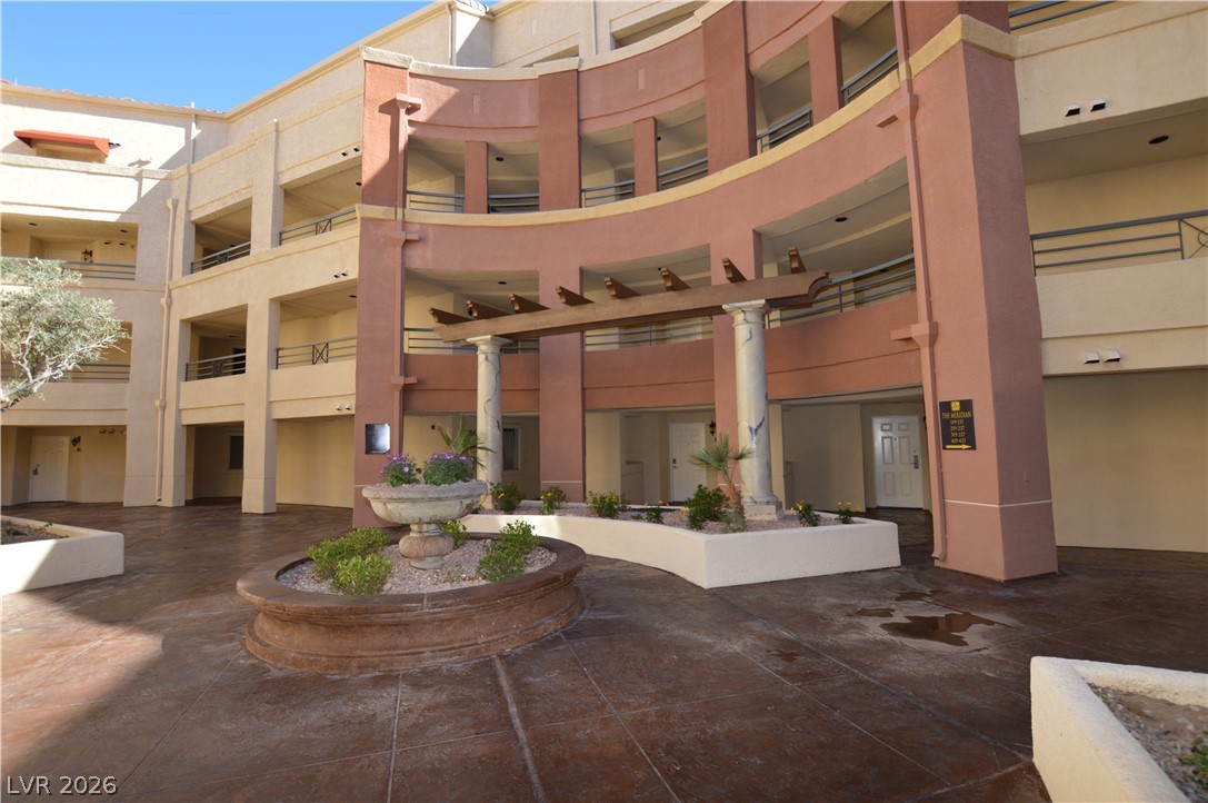 230 East Flamingo Road, Unit 334 Las Vegas, NV 89169 - Photo 27 of 37 An inviting courtyard welcomes with paved walkways and distinctive architectural curves.