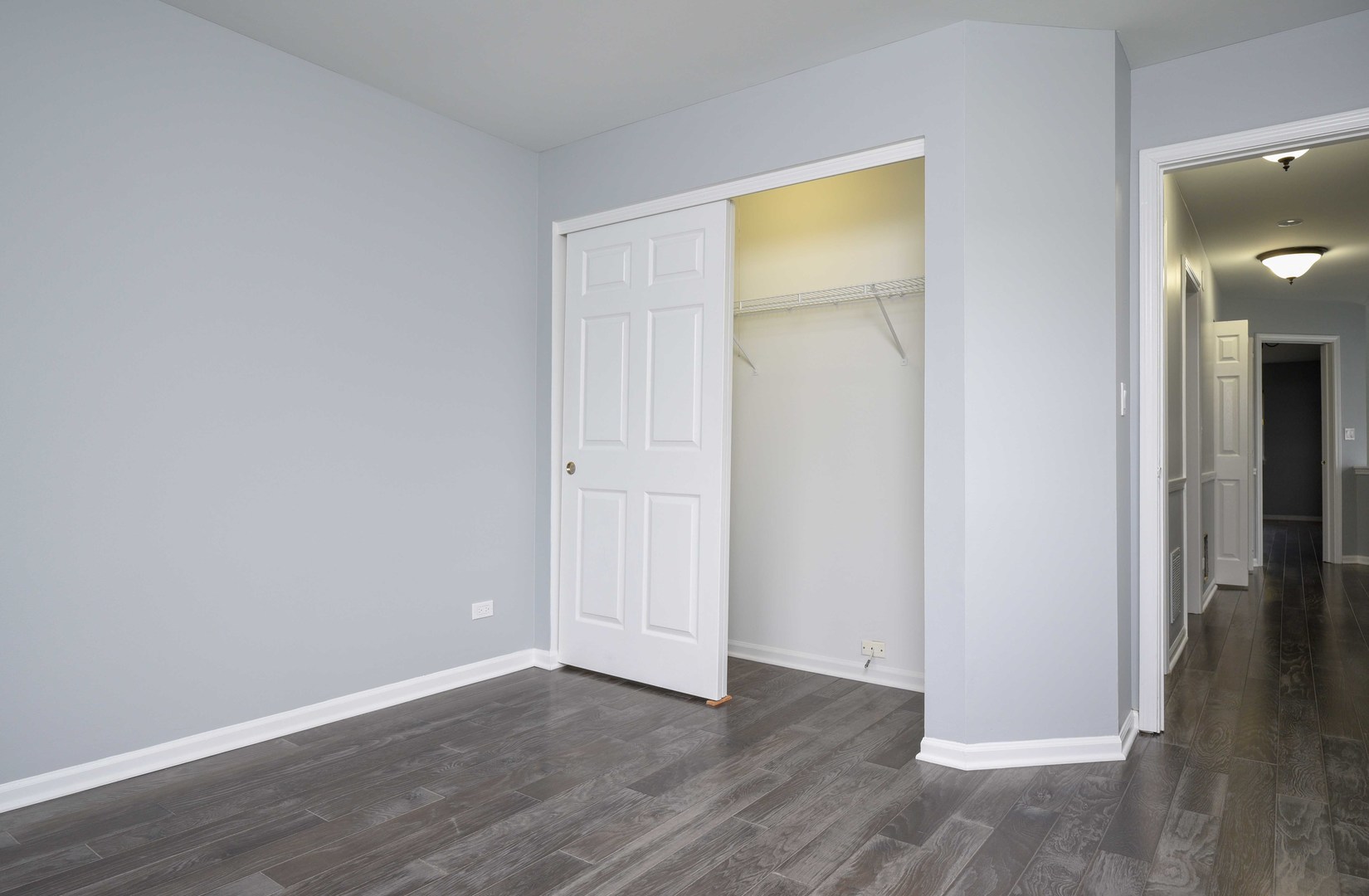 1032 Ripple Ridge, Unit 19 Darien, IL 60561 - Photo 18 of 28 an empty room with wooden floor and closet