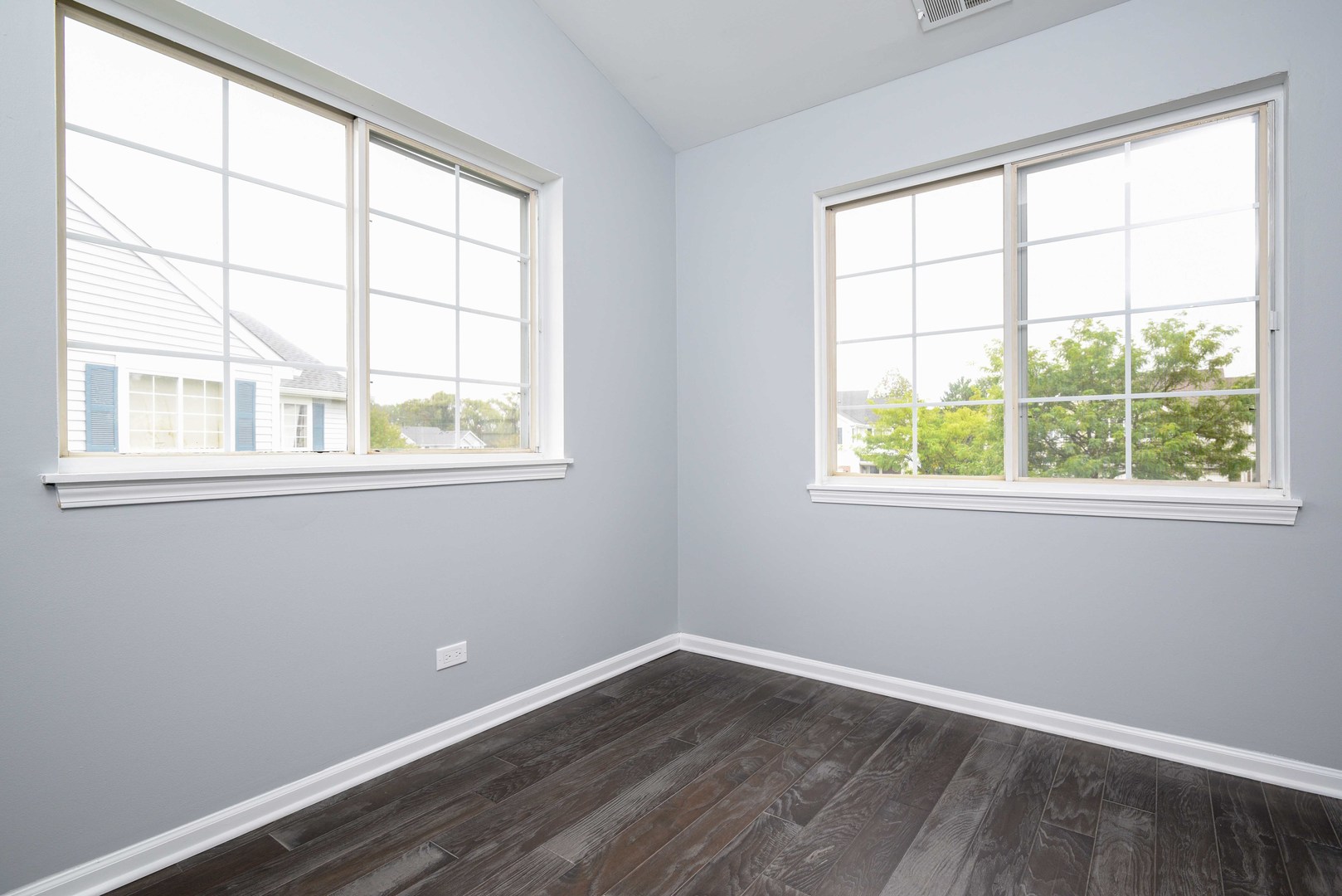 1032 Ripple Ridge, Unit 19 Darien, IL 60561 - Photo 20 of 28 an empty room with wooden floor and windows