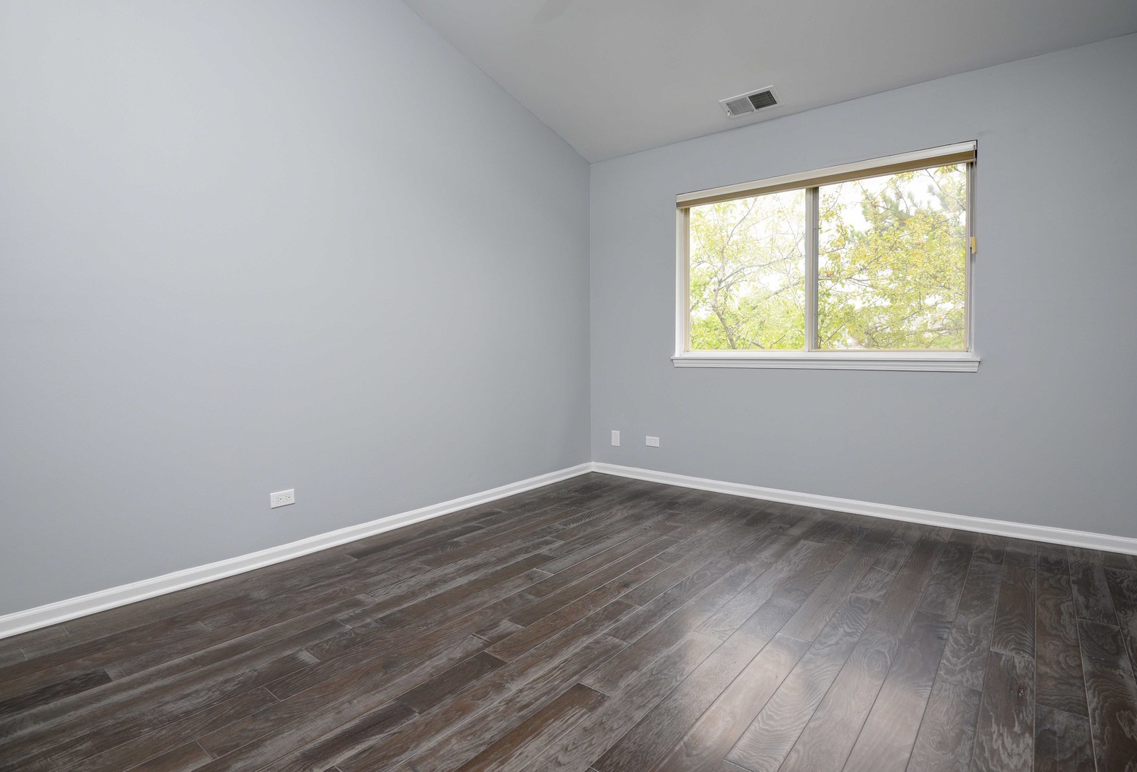 1032 Ripple Ridge, Unit 19 Darien, IL 60561 - Photo 21 of 28 a view of an empty room with wooden floor and a window