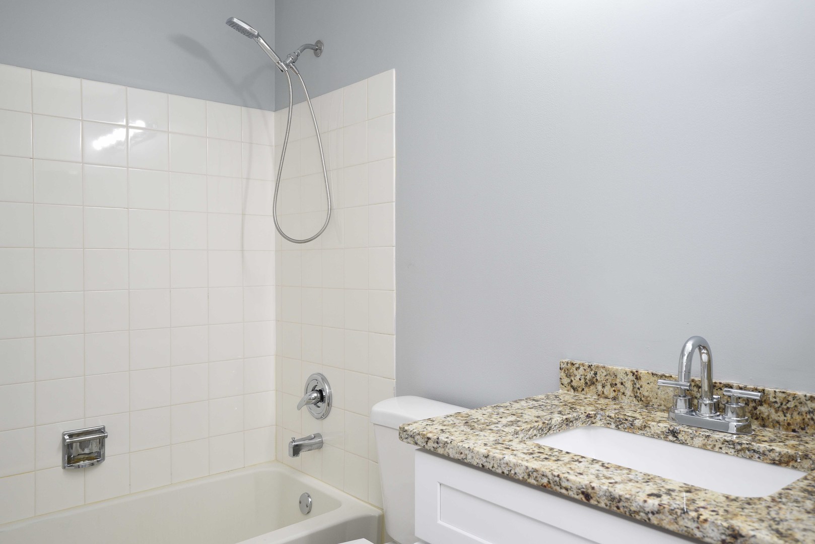 1032 Ripple Ridge, Unit 19 Darien, IL 60561 - Photo 24 of 28 a bathroom with a granite countertop sink a toilet and shower