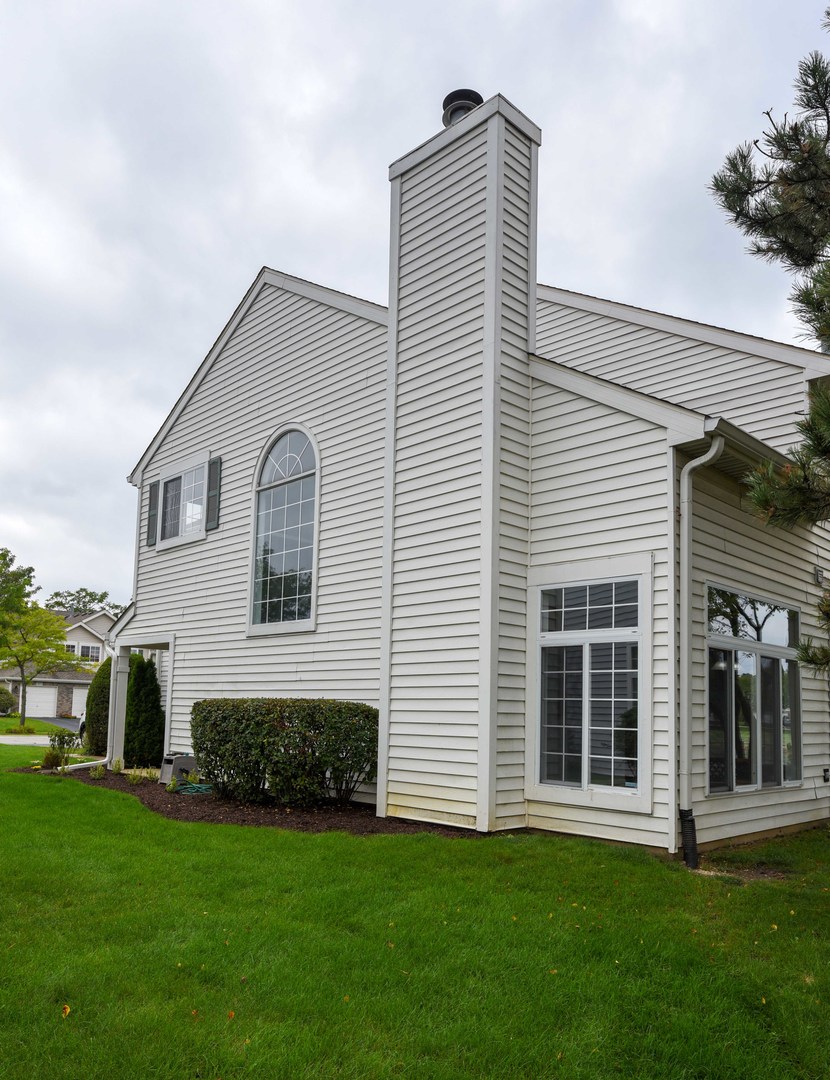 1032 Ripple Ridge, Unit 19 Darien, IL 60561 - Photo 27 of 28 a front view of a house with a garden