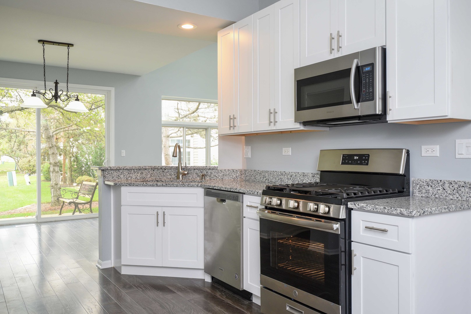 1032 Ripple Ridge, Unit 19 Darien, IL 60561 - Photo 6 of 28 a kitchen with stainless steel appliances granite countertop a stove top oven a sink dishwasher and a microwave oven with cabinets