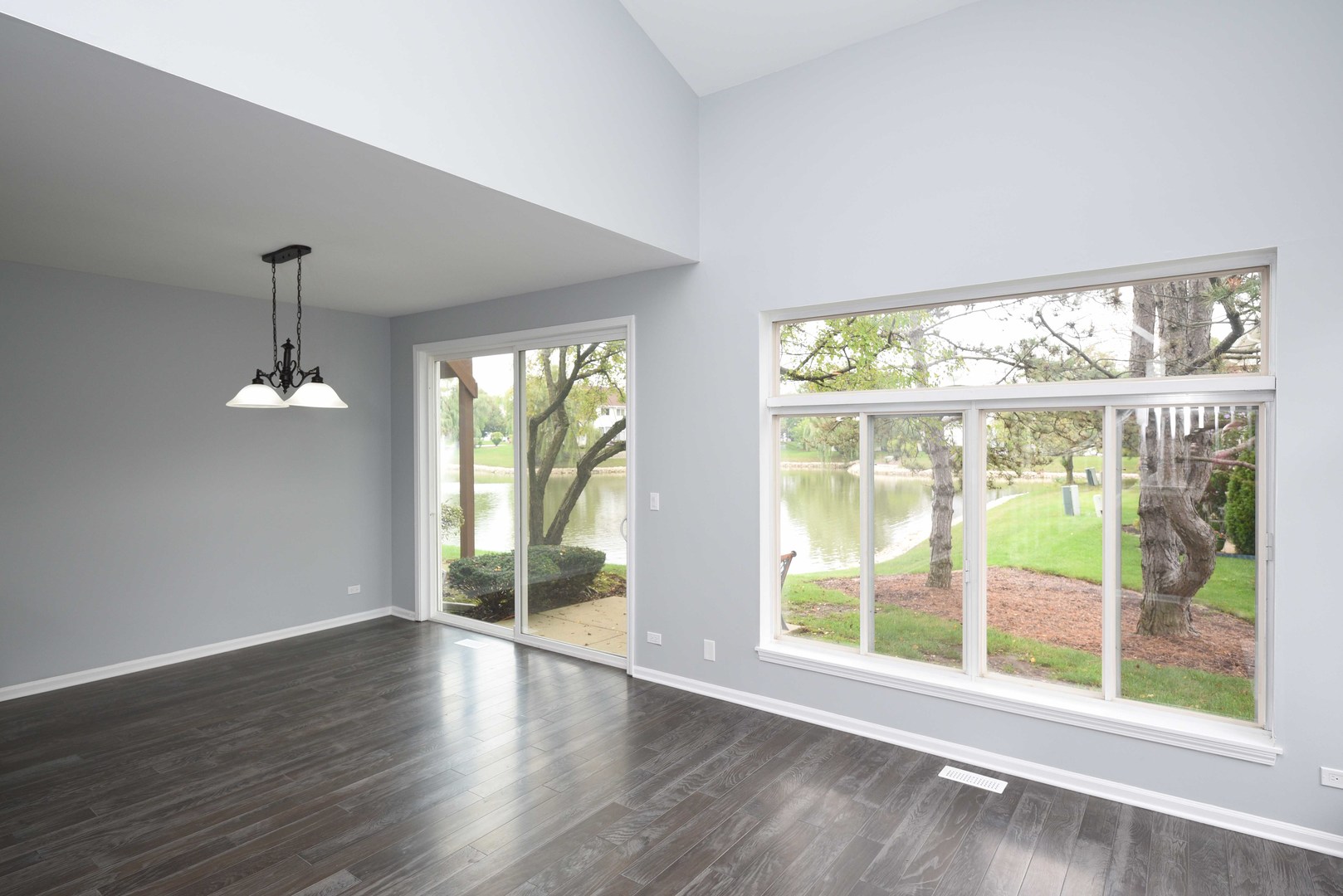 1032 Ripple Ridge, Unit 19 Darien, IL 60561 - Photo 9 of 28 a view of an empty room with wooden floor and a window