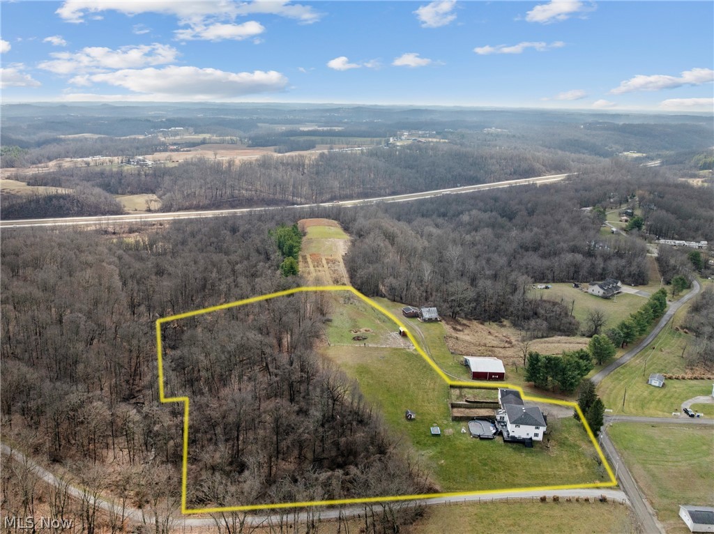 64508 Slade Road Cambridge, OH 43725 - Photo 2 of 50 Aerial view of property and surrounding area with a forest and property boundaries highlighted