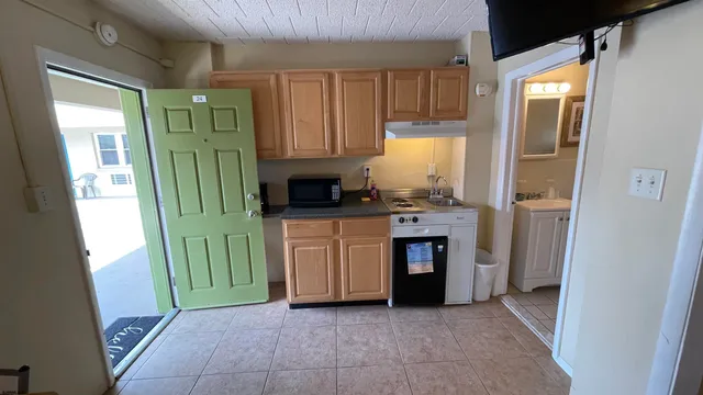 a kitchen with stainless steel appliances granite countertop a stove a refrigerator and a microwave