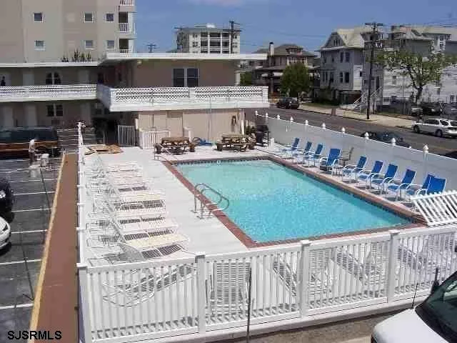 a view of a swimming pool with outdoor seating