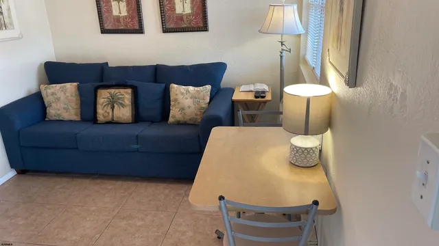 a living room with furniture and a lamp