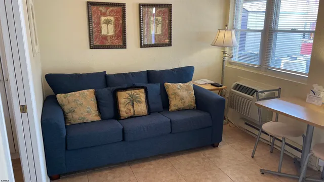 a living room with furniture and a lamp