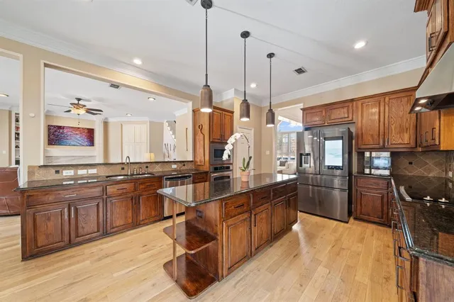 a large kitchen with lots of counter space a sink and appliances