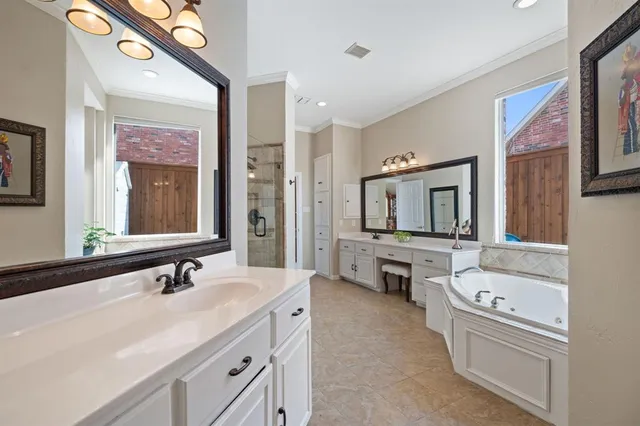 a bathroom with a granite countertop tub sink and mirror