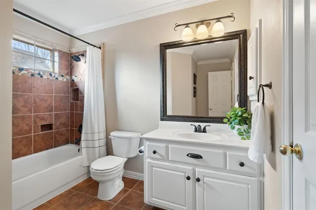 a bathroom with a sink vanity mirror toilet and bathtub
