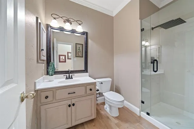 a bathroom with a sink vanity mirror and toilet