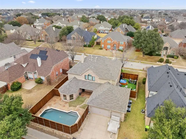 an aerial view of residential houses with outdoor space