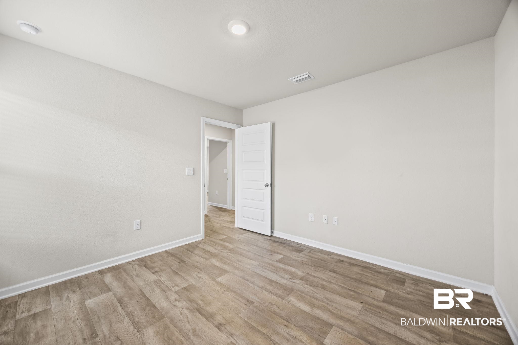 3090 Camino Real Loop Lillian, AL 36549 - Photo 22 of 29 Unfurnished room featuring wood finished floors and baseboards