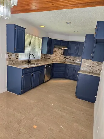 a room with a chandelier fan and windows