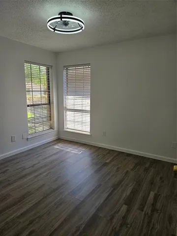 a bathroom with a granite countertop toilet sink and mirror