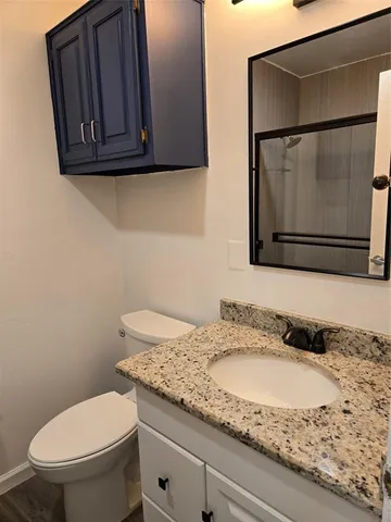 a view of empty room with wooden floor and window