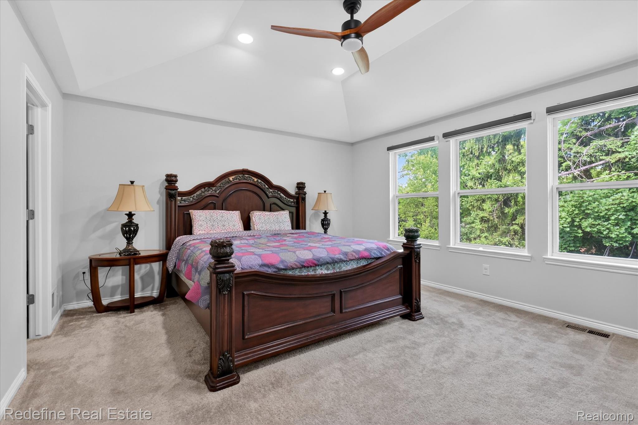 2976 Andlaur Drive Rochester, MI 48307 - Photo 24 of 60 Vaulted ceiling room featuring light gray walls, plush carpet flooring, three large windows, a ceiling fan with integrated lighting, and recessed ceiling lights