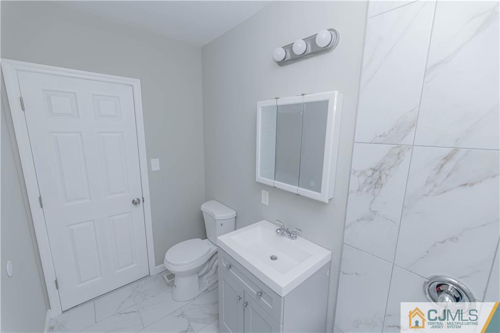 7 North Shore Boulevard Helmetta, NJ 08828 - Photo 16 of 50 a bathroom with a toilet a sink and a mirror