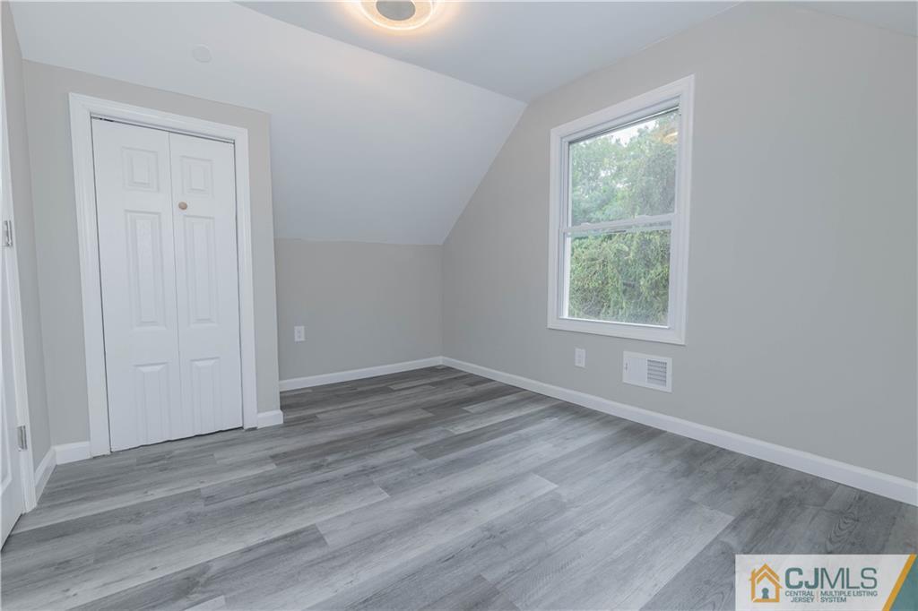 7 North Shore Boulevard Helmetta, NJ 08828 - Photo 26 of 50 an empty room with wooden floor and windows