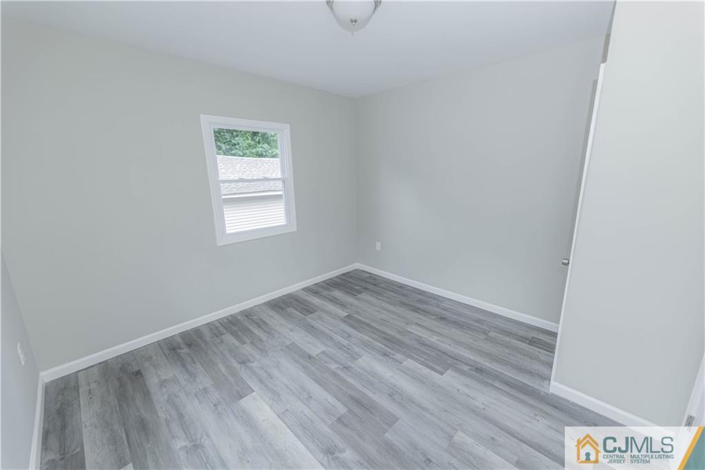7 North Shore Boulevard Helmetta, NJ 08828 - Photo 28 of 50 a view of an empty room with wooden floor and a window