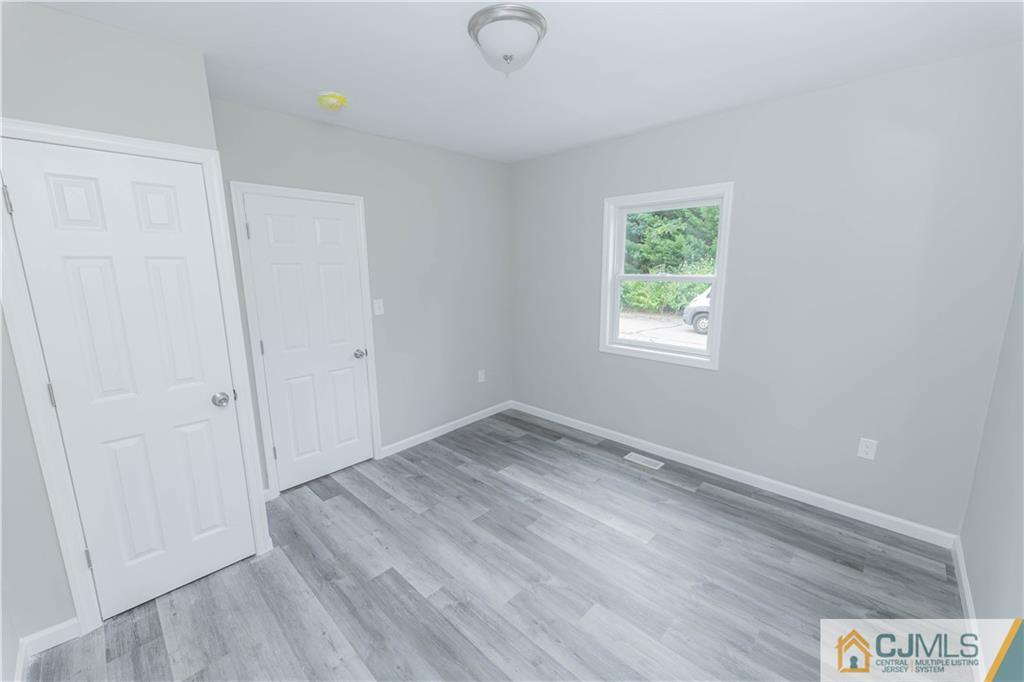 7 North Shore Boulevard Helmetta, NJ 08828 - Photo 32 of 50 an empty room with wooden floor and windows