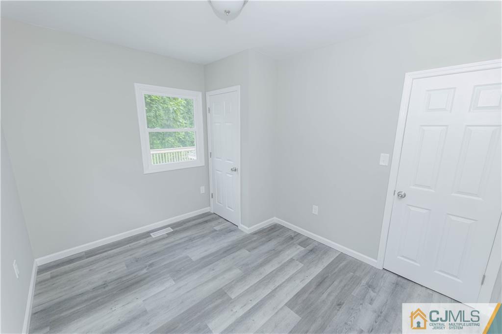 7 North Shore Boulevard Helmetta, NJ 08828 - Photo 34 of 50 an empty room with wooden floor and window