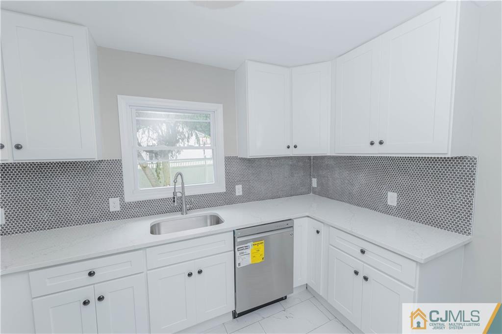 7 North Shore Boulevard Helmetta, NJ 08828 - Photo 5 of 50 a kitchen with cabinets appliances and a sink