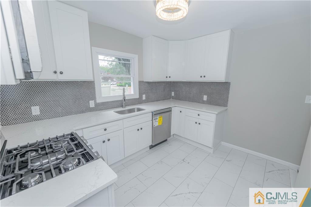 7 North Shore Boulevard Helmetta, NJ 08828 - Photo 7 of 50 a kitchen with a sink stove and cabinets