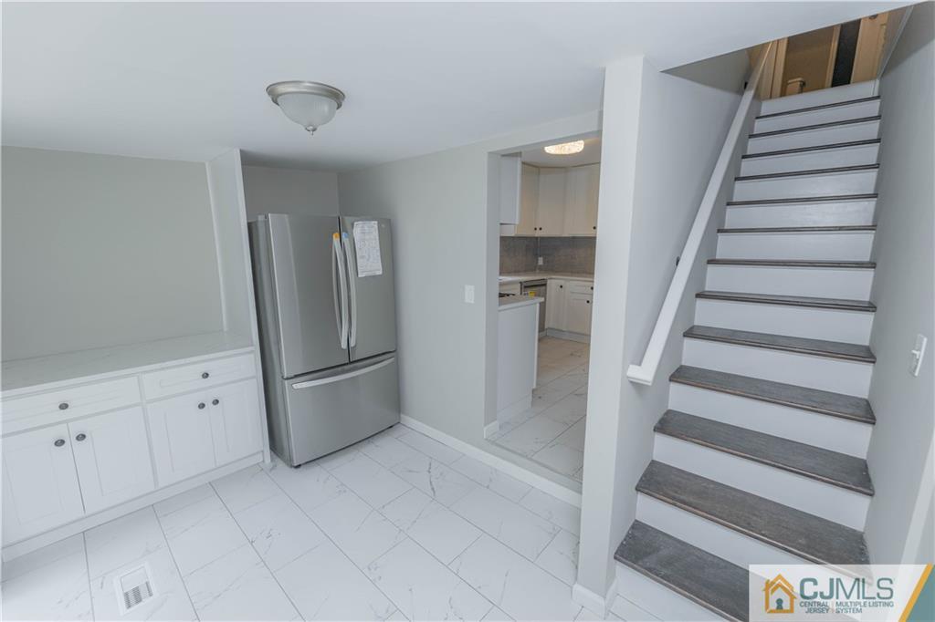 7 North Shore Boulevard Helmetta, NJ 08828 - Photo 8 of 50 a view of a kitchen with refrigerator and stairs