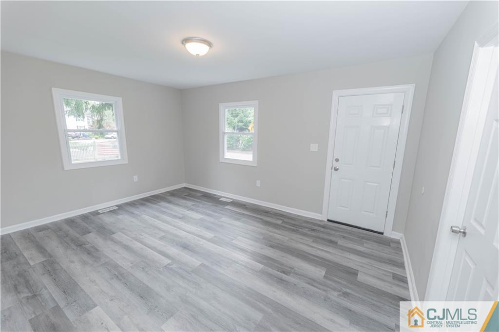 7 North Shore Boulevard Helmetta, NJ 08828 - Photo 9 of 50 a view of an empty room with wooden floor and a window